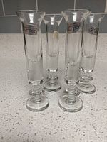 Five dram glasses standing upright showing shape and decals