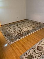 Full view of wool floral area rug on hardwood floor