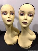 Two mannequin heads front view