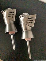 Pair of knight helmet pourer stoppers showing full length and spouts