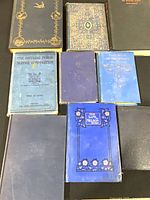 Group of nine books laid flat showing front covers