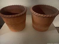 Both terracotta planters side by side