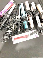 Group of eight corded hair styling tools plus packaged comb