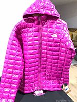 Full front view of pink ThermoBall Eco jacket with hood, tags visible