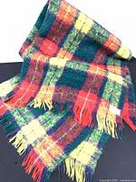 Full view of multicolor plaid mohair blanket draped to show size and pattern