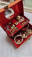 Open jewelry box showing assorted costume jewelry pieces