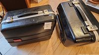 two black motorcycle pannier cases side by side