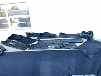 Overview of multiple black canvas bags spread out on table