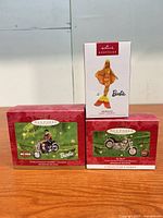 Front view of all three boxed Hallmark ornaments