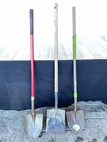 Three shovels standing side by side