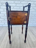 Full view of cabinet showing turned legs, door closed