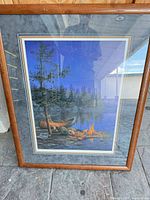 Full view of framed print showing wood frame and mat