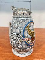 Front three-quarter view of Harley-Davidson stein showing eagle emblem and lid