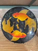 Full view of painted koi plate on stand