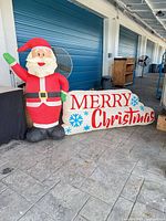 Full view of inflatable Santa and sign