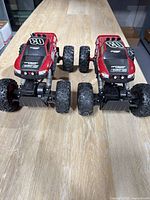 Front view of both Maisto off-road trucks