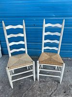 Pair of wooden ladder-back chairs front view