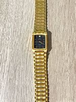 Full view of gold-tone Elgin wristwatch showing bracelet and case