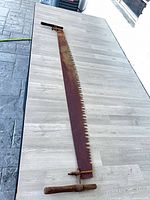 Full view of long crosscut saw on table