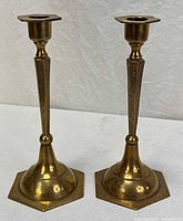 Front view of both etched brass candlestick holders