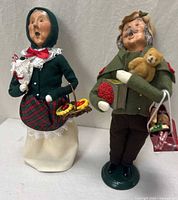 Both Byers' Choice caroler figurines standing side by side