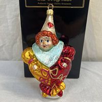 Front view of ornament in front of Radko box