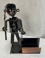 Full view of metal fisherman sculpture and card holder