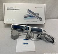 Lamp, power adapter, goggles, manual and box group shot