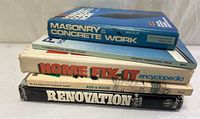 Stack of five home improvement books showing titles and thickness
