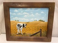Full view of framed cow landscape painting