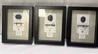 Front view of three framed proverb art pieces
