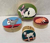 Four hand-painted wooden boxes showing all lids with animal motifs