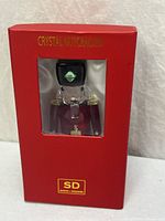 Front of boxed crystal nutcracker showing window and title