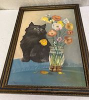Full view of framed painting showing cat, vase of flowers, ornate frame