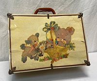 Front view of cream doll trunk showing full animal illustration and handle