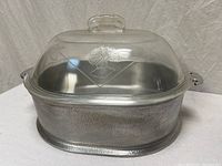 Full view of roaster with lid attached, showing hammered aluminum body and embossed glass lid