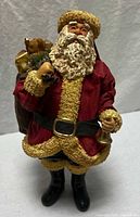 Full view of Santa figure with bell and toy sack