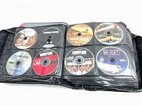 Binder open showing first set of disc sleeves with six movie DVDs