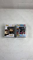 Both unopened Funko Pop figures side by side