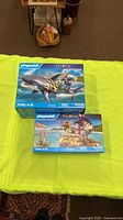 Both boxed Playmobil Pirates sets displayed on table