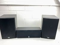 Front view showing two NS-A637 speakers and NS-AC143 center speaker