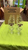 Six Allagash glasses beside original shipping box