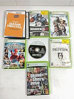 Top-down view of all eight Xbox 360 games showing cases and Call of Duty 4 disc