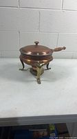 Copper fondue pot with lid on brass stand