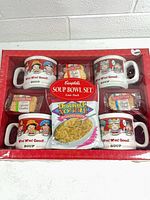 Front of sealed four-pack showing four mugs with Campbell’s Kids graphics