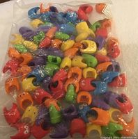 Bag front showing colourful rubber pencil toppers