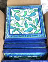 Box opened showing multiple sealed paisley napkin packs