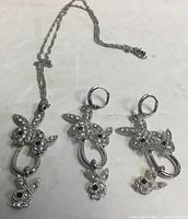 Full set showing necklace and both earrings laid flat