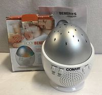 Device placed beside retail box and manual