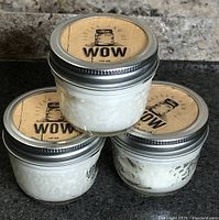 Three stacked jars showing labels and contents